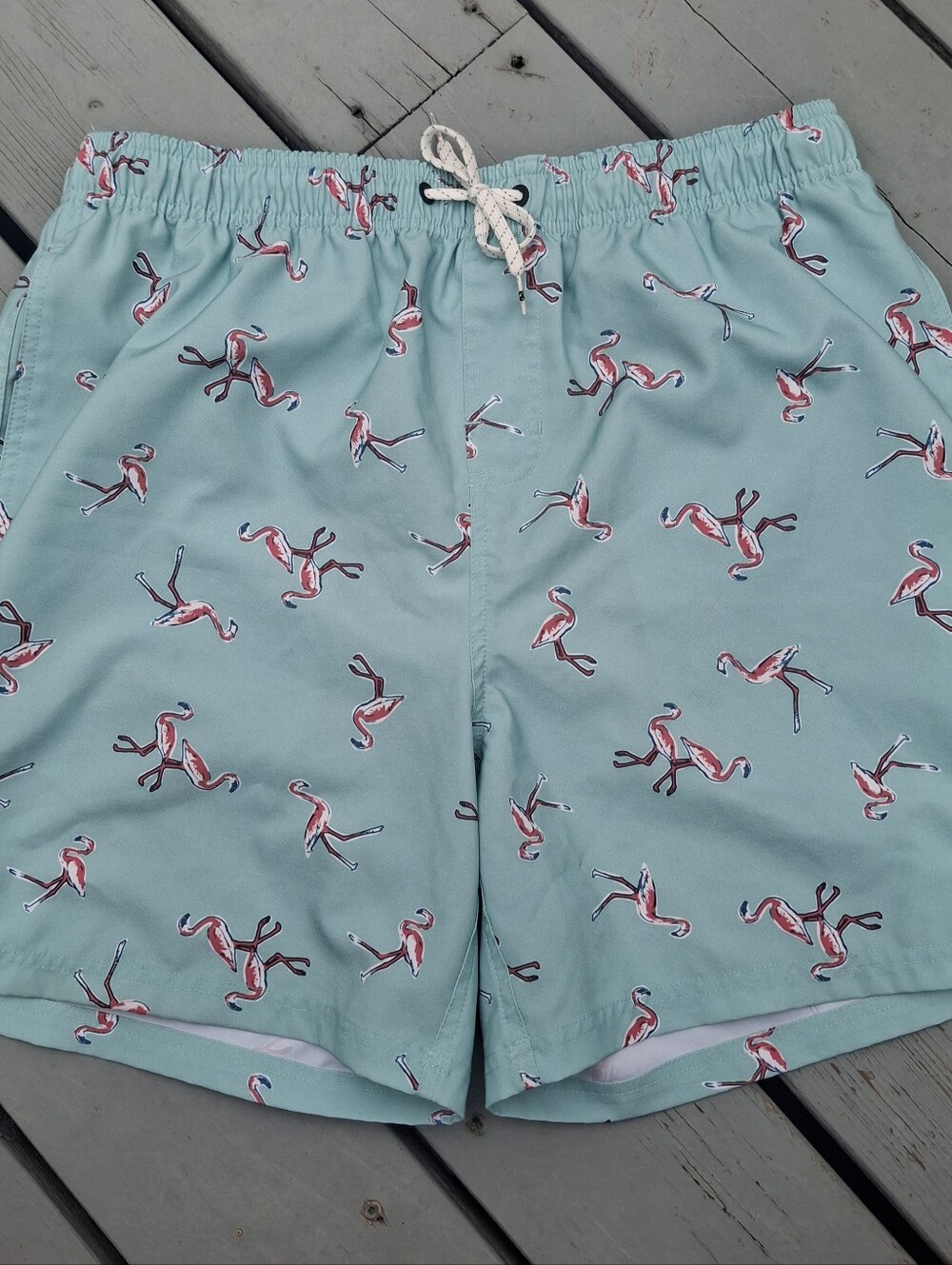 Ocean Current Mint Green Swim Trunks with Pink Flamingo Print